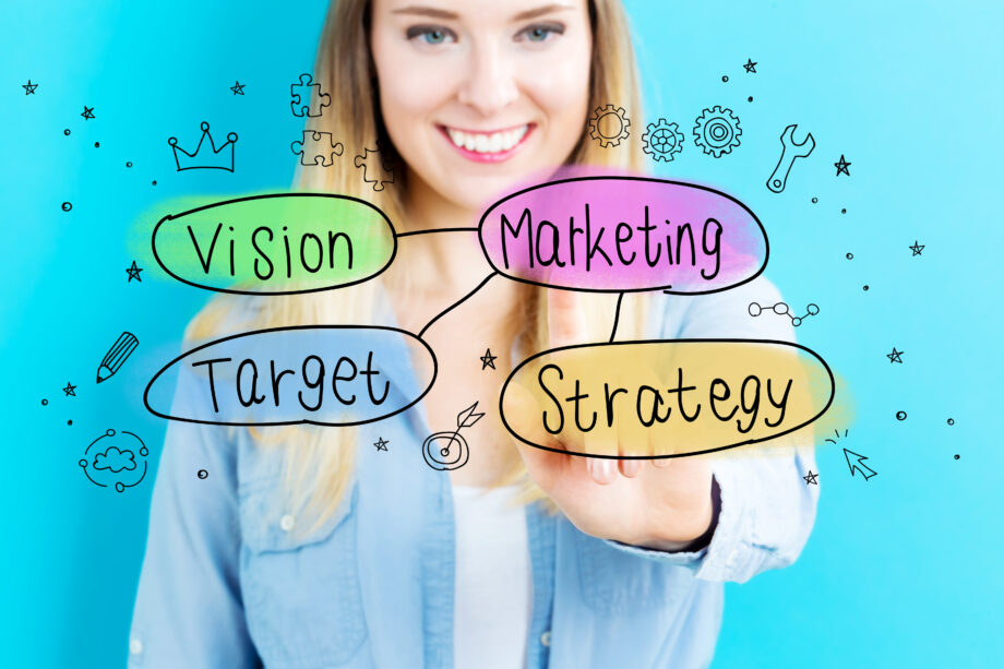 A woman smiles in the background. In the foreground, colorful bubbles labeled "Vision," "Target," "Marketing," and "Strategy" are surrounded by sketched icons on a blue background.